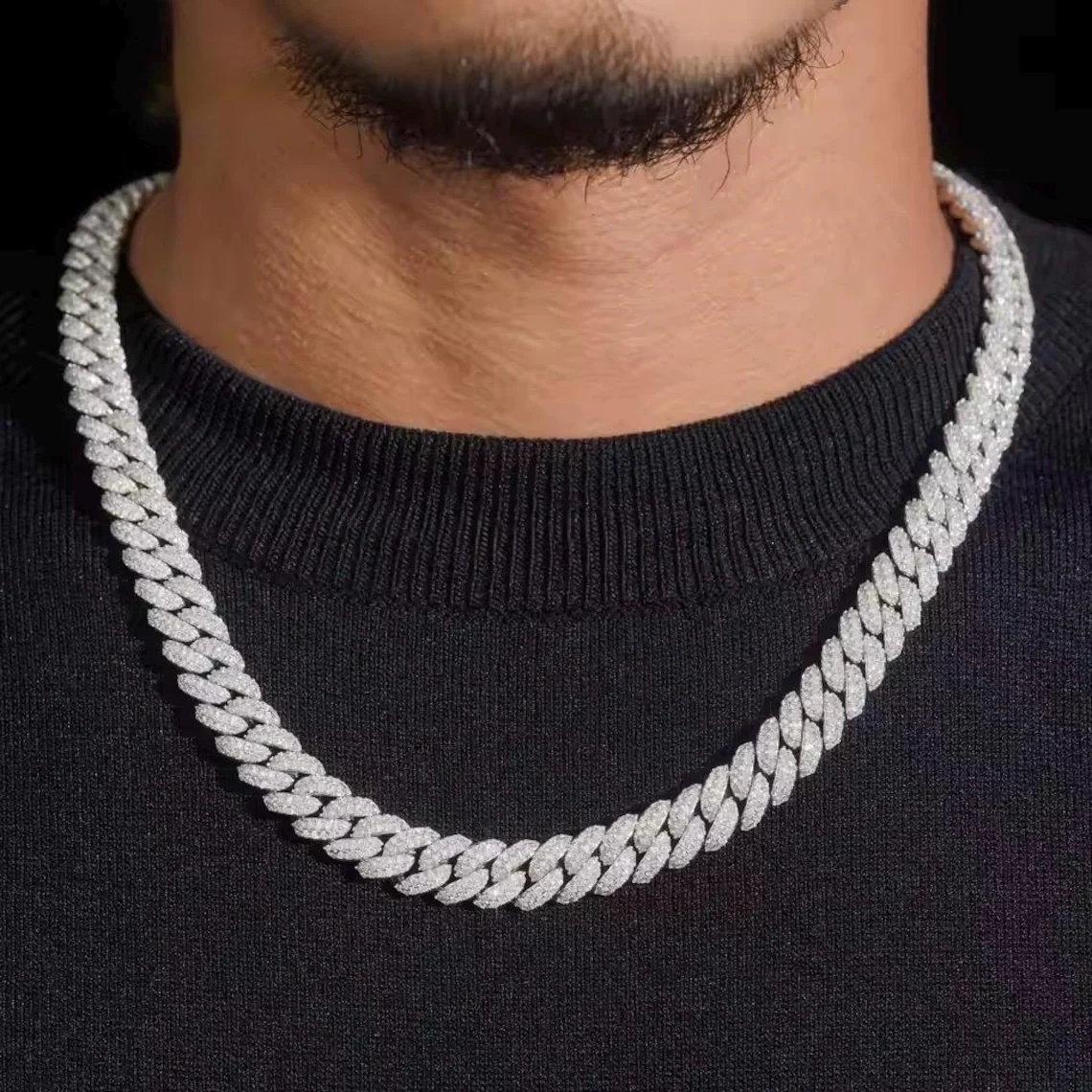 Heavy 12mm iced-out Cuban link chain in gold, showing how metal gauge drives cost at 2026 gold prices
